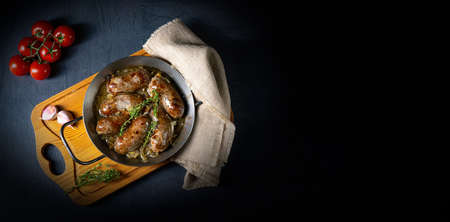 Homemade white sausage fried with onion and herbs