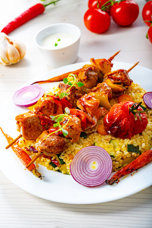 Shish kebabs with vegetables and bulgurの写真素材