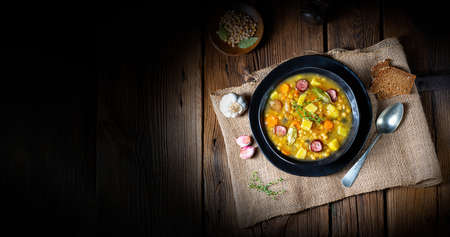 Rustic pea soup with bacon and sausagesの写真素材