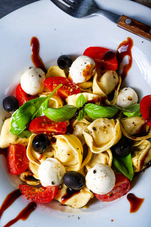 rustic tortellini pasta salad with mozzarellaの写真素材