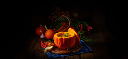 Delicious autumn pumpkin soup with baguetteの写真素材
