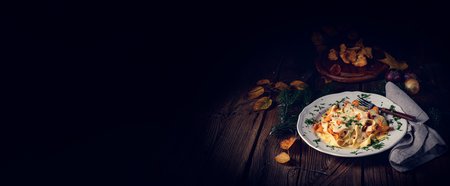 Tagliatelle with fresh chanterelles in a mushroom sauceの写真素材