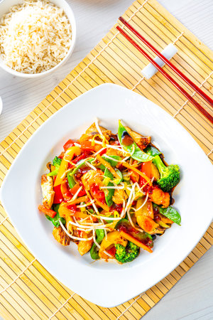 sweet and sour chicken with rice and vegetablesの写真素材