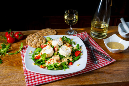 Rocket salad with goat cheese and honey dressingの写真素材