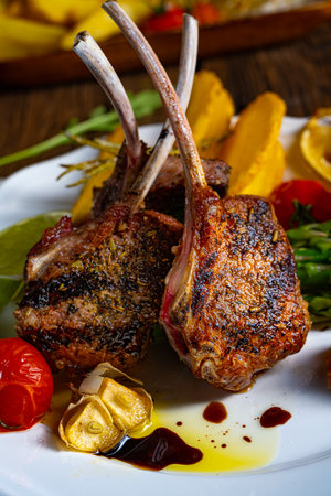 Lamb chops marinated in herbs with green asparagus and limeの写真素材