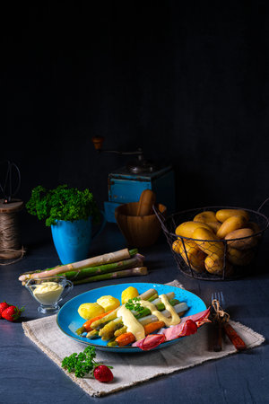 Asparagus with black forest ham, carrots and hollandaise sauce.の写真素材