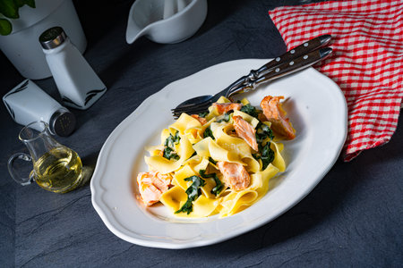 Tagliatelle with salmon and spinach in a cream sauceの写真素材