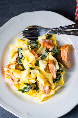 Tagliatelle with salmon and spinach in a cream sauceの写真素材