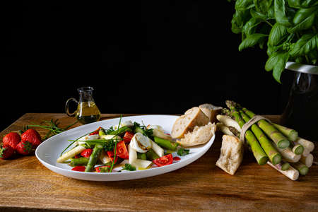 Asparagus salad with strawberries, tomatoes and goat cheeseの写真素材