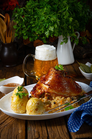 pork knuckle with sauerkraut and sweet mustardの写真素材