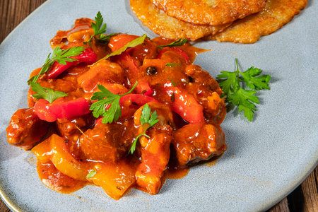 Original Hungarian goulash with potato pancakesの写真素材