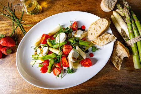 Asparagus salad with strawberries, tomatoes and goat cheeseの写真素材