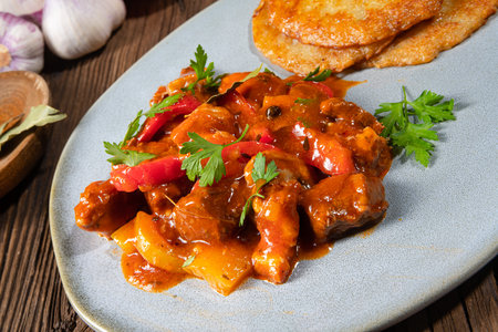 Original Hungarian goulash with potato pancakesの写真素材