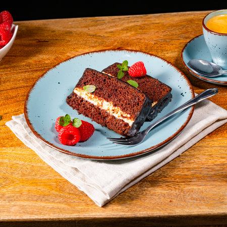 Rustic chocolate cake with raspberries and coffeeの写真素材