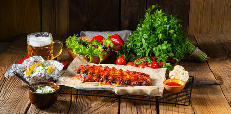 spicy spare ribs with baked potatoes and sour creamの写真素材