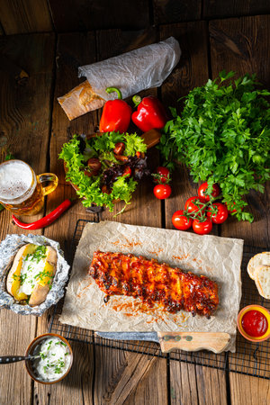spicy spare ribs with baked potatoes and sour creamの写真素材