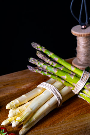 Green and white asparagus on the tableの写真素材