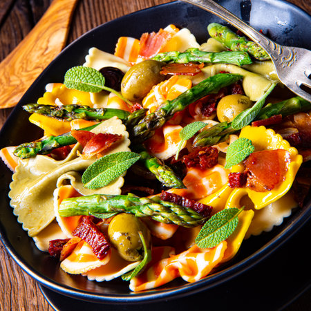Pasta salad with green asparagus, olives and parma hamの写真素材