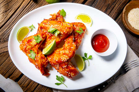 Chicken wings with potato wedges and sezam.の写真素材