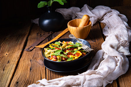 Pasta salad with green asparagus, olives and parma hamの写真素材