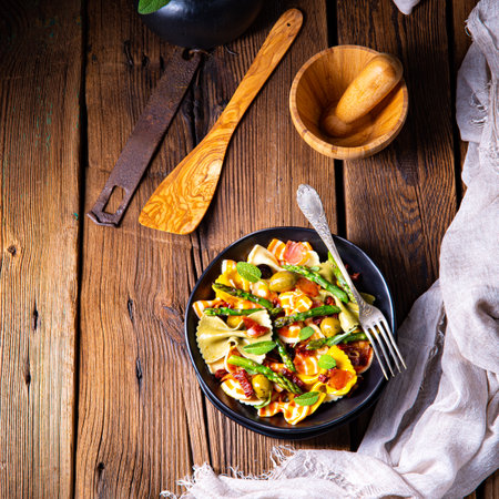 Pasta salad with green asparagus, olives and parma hamの写真素材