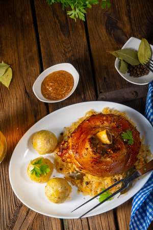 pork knuckle with sauerkraut and sweet mustardの写真素材
