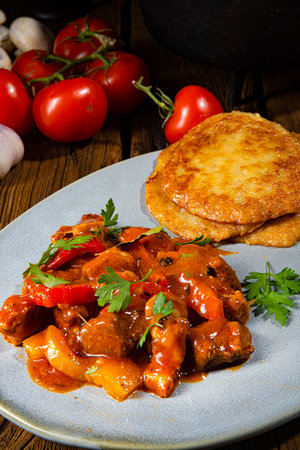 Spicy pork stew with potato pancakesの写真素材