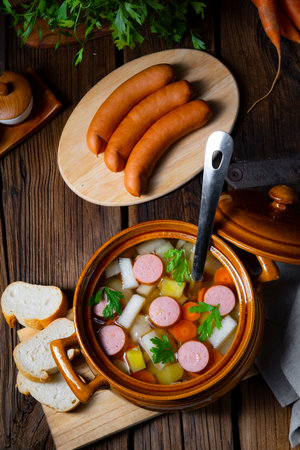 Potato kohlrabi soup with bockwurstの写真素材