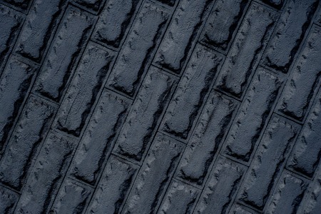 black glansing brick wall background in diagonalの写真素材
