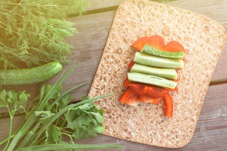 Pitta bread with green-stuff vegatables during summer barbecue with cutted red bell papers. Concept of healthy foodの写真素材