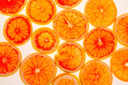 lots of orange slices on white background flat lay