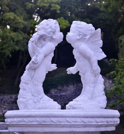 Sculpture of two little angels kissing. Urban arts and architecture examples of Ukraineの写真素材
