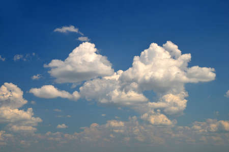 Gorgeous white clouds flying in the deep blue summer sky