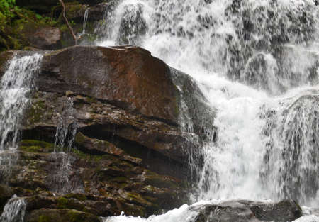 Waterfall breaking apart on old stones