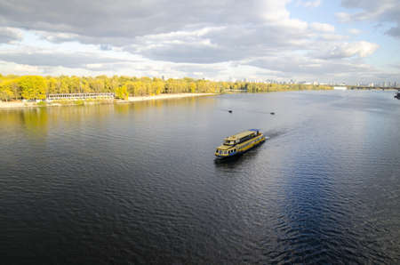 A cruiser in the river and autumn forest background, water surfaceの写真素材