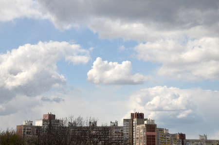 Natural cloudscape over modern city, summer clouds and houses backgroundの写真素材