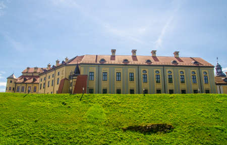 Building of an ancient castle standing on green hills, picturesque tourist locations in Europe