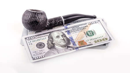 Money background, US dollars with a pipe isolated over white background, gentleman's set, conceptual photoの写真素材