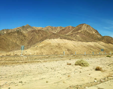 Road going through Sinai desert, picturesque backgound with mountains and hills, desert landscape...