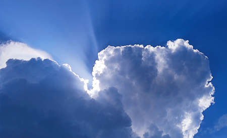 Single white cloud in the blue sky natural background. Deep blue summer sky with white fluffy cloud...