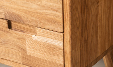 Bedside table with drawers close view photo, wooden eco furniture elements background. Solid wood furniture detailsの写真素材