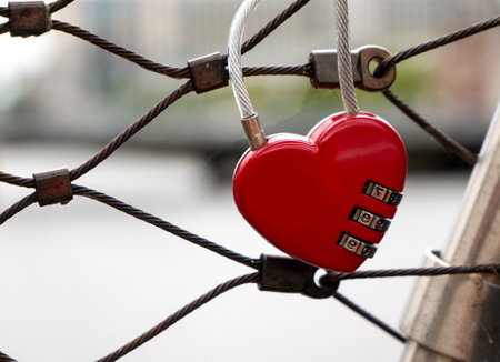Heart lock at the bridge, red heart lock with a code, love and passion photo. A password from my heart conceptの写真素材