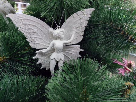 Fur tree branches with Christmas angels and fairies, New Year tree close view. Holiday Christmas background wallpaperの写真素材