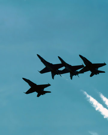 Airshow of military jet fighters. Group of military airplanes performs maneuvers with a smoke trace....