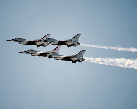 Airshow of military jet fighters. Group of military airplanes performs maneuvers with a smoke trace....