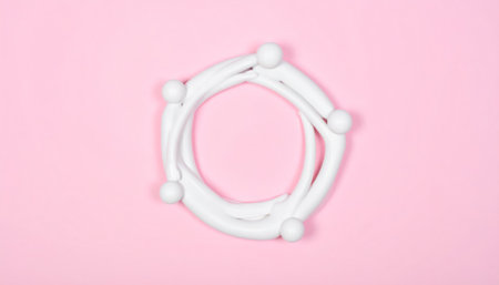 Circle made of white plasticine on a pink background. Minimal conceptの素材