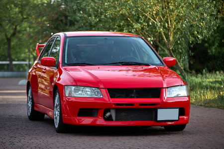 red car on the road in the city, closeup of photo