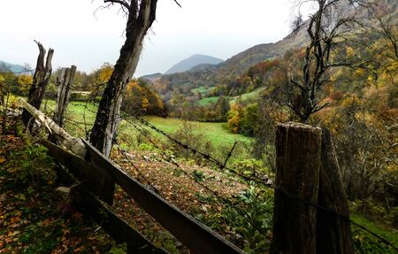 Fenced road through mountain village, autumn sceneの写真素材
