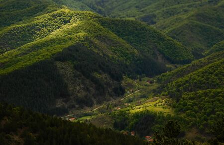 Valley illuminated by the first rays of the sun, rural mountain area, landscapeの写真素材
