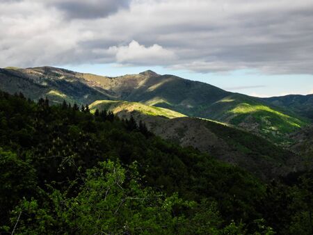 Valley illuminated by the first rays of the sun, rural mountain area, landscapeの写真素材